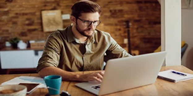 A person sitting at a desk using a computer

AI-generated content may be incorrect.